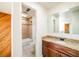 Bathroom vanity featuring granite countertop, dark wood cabinets, large mirror, and a combined shower and tub at 1233 S Yosemite Way # 74, Denver, CO 80247