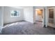 Spacious bedroom with neutral carpet, white walls, and a window overlooking a pleasant street view at 1233 S Yosemite Way # 74, Denver, CO 80247