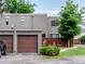 Townhouse with a private garage, well-kept landscaping, and a red-fenced yard at 1233 S Yosemite Way # 74, Denver, CO 80247