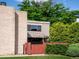 Charming townhouse featuring a red-fenced courtyard with lush landscaping and brick accents at 1233 S Yosemite Way # 74, Denver, CO 80247