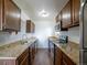 Galley kitchen features stainless steel appliances, granite counters, wood cabinets, and hardwood flooring at 1233 S Yosemite Way # 74, Denver, CO 80247