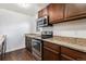 Modern kitchen with stainless steel appliances and granite countertops at 1233 S Yosemite Way # 74, Denver, CO 80247