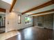 Open living room featuring a brick fireplace and exposed wood beams at 1233 S Yosemite Way # 74, Denver, CO 80247