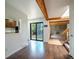 Bright living room with exposed wood beams, fireplace, and backyard view at 1233 S Yosemite Way # 74, Denver, CO 80247