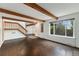 Open concept living room with hardwood floors, exposed beams, and staircase at 1233 S Yosemite Way # 74, Denver, CO 80247