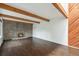 Spacious living room with a brick fireplace, hardwood floors and wood beam ceiling at 1233 S Yosemite Way # 74, Denver, CO 80247