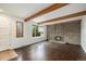 Bright living room featuring a brick fireplace and exposed wood beams at 1233 S Yosemite Way # 74, Denver, CO 80247