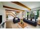 Spacious living room features wood beams, stairs, and a large window at 1233 S Yosemite Way # 74, Denver, CO 80247