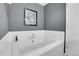 Relaxing bathroom with soaking tub and tile surround at 6942 W Alaska Dr, Lakewood, CO 80226