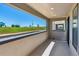 Covered balcony boasting views of a well-maintained lawn and clear blue sky, perfect for outdoor relaxation at 11487 E Briarwood Cir, Centennial, CO 80112