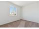 Neutral bedroom with wall-to-wall carpeting and a sun-filled window at 11487 E Briarwood Cir, Centennial, CO 80112