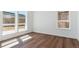 Bright bedroom featuring modern wood floors and large windows offering great natural light at 11487 E Briarwood Cir, Centennial, CO 80112