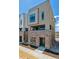 Modern townhome featuring brick base, neutral siding, and contemporary windows under a bright sky at 11487 E Briarwood Cir, Centennial, CO 80112