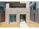 Modern home featuring a brick facade, large windows, and sleek contemporary design at 11487 E Briarwood Cir, Centennial, CO 80112