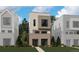 Modern home with brick facade, large windows and neutral color palette in a suburban setting at 11487 E Briarwood Cir, Centennial, CO 80112
