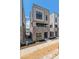 Modern townhome with brick base, beige siding, and a clean, contemporary design on a sunny day at 11487 E Briarwood Cir, Centennial, CO 80112