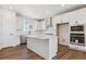 Bright, all-white kitchen showcases stainless steel appliances, an island, and ample cabinet space at 11487 E Briarwood Cir, Centennial, CO 80112