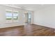Bright living space featuring wood floors, large windows and a sliding glass door to balcony at 11487 E Briarwood Cir, Centennial, CO 80112