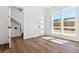 Bright, open living room featuring hardwood floors, modern staircase, and abundant natural light at 11487 E Briarwood Cir, Centennial, CO 80112