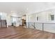 Open-concept living space featuring hardwood floors, a staircase, and a modern kitchen with a center island at 11487 E Briarwood Cir, Centennial, CO 80112