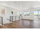 Open loft with wood flooring, modern railing, and plenty of natural light, ideal for flexible use at 11487 E Briarwood Cir, Centennial, CO 80112