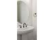 Close up of powder room sink and faucet with round mirror and simple design at 11487 E Briarwood Cir, Centennial, CO 80112