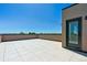 Spacious rooftop deck features neutral tile flooring and a glass paneled door at 11487 E Briarwood Cir, Centennial, CO 80112