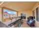 Covered patio with dining furniture, grill and neighborhood view, perfect for outdoor entertainment at 1706 Ghost Dance Cir, Castle Rock, CO 80108