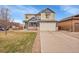 Inviting two-story home boasts a well-manicured lawn, a two-car garage, and a classic architectural design at 1706 Ghost Dance Cir, Castle Rock, CO 80108