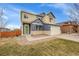 Charming two-story home featuring blue and beige siding, a two-car garage, and well-maintained landscaping at 1706 Ghost Dance Cir, Castle Rock, CO 80108