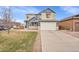 Inviting two-story home boasts a well-manicured lawn, a two-car garage, and a classic architectural design at 1706 Ghost Dance Cir, Castle Rock, CO 80108