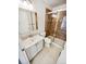 Updated bathroom featuring a tiled shower, modern sink and vanity, and ample lighting at 16750 E Ada Pl, Aurora, CO 80017