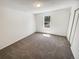 Cozy bedroom features a window and neutral carpet at 16750 E Ada Pl, Aurora, CO 80017