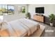 Well-lit bedroom showcasing two large windows and a stylish dresser at 16750 E Ada Pl, Aurora, CO 80017