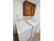 Laundry room includes washer, dryer, and cabinet at 16750 E Ada Pl, Aurora, CO 80017