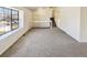 Spacious living room with large window for plenty of natural light and neutral carpeting throughout at 16750 E Ada Pl, Aurora, CO 80017