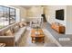 Bright living room features neutral tones, large windows, and staircase access at 16750 E Ada Pl, Aurora, CO 80017