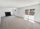 Spacious living room with a fireplace and sliding glass door to the backyard at 16750 E Ada Pl, Aurora, CO 80017