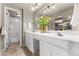 Bright bathroom with double sinks, white cabinets, and decor at 130 N Pearl St # 805, Denver, CO 80203