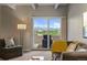 Living room with sliding glass door leading to a balcony and mountain views at 130 N Pearl St # 805, Denver, CO 80203