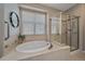Clean bathroom with a soaking tub and a separate shower, offering convenience and relaxation at 6673 S Benton St, Littleton, CO 80123