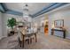 Elegant dining room with decorative lighting open to the living and kitchen area at 6673 S Benton St, Littleton, CO 80123