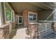 Inviting front porch with stone columns and neutral accents, creating a warm welcome at 6673 S Benton St, Littleton, CO 80123