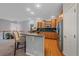 Modern kitchen with stainless steel appliances, granite countertops, and bar-style seating at 6673 S Benton St, Littleton, CO 80123