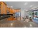 Updated kitchen featuring stainless steel appliances, granite countertops, and eat-in counter at 6673 S Benton St, Littleton, CO 80123