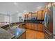 Modern kitchen with stainless steel appliances, granite countertops, and hardwood floors at 6673 S Benton St, Littleton, CO 80123