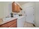 Bright laundry area features tile flooring, utility sink, and convenient washer and dryer at 6673 S Benton St, Littleton, CO 80123