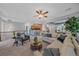 Open-concept living room flows into kitchen and dining, perfect for modern living and entertaining at 6673 S Benton St, Littleton, CO 80123