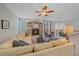 Cozy living room featuring a fireplace, comfortable seating, and plenty of natural light at 6673 S Benton St, Littleton, CO 80123
