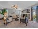 Spacious living room with a fireplace, plush seating, and access to the backyard at 6673 S Benton St, Littleton, CO 80123